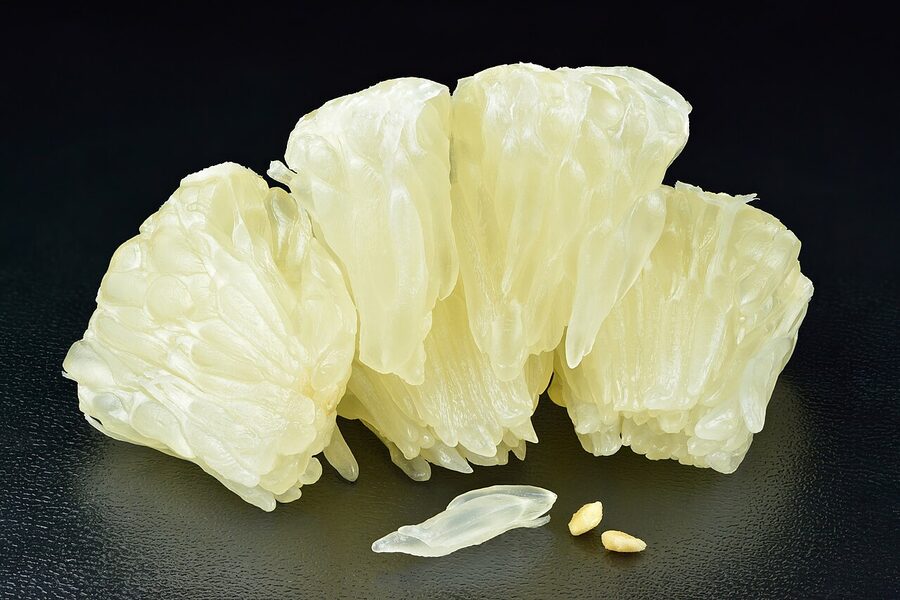 Pomelo flesh showing segmented pink sacs