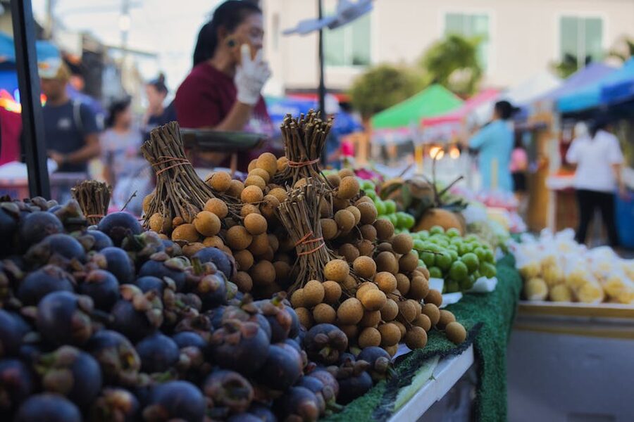 Thai wet market with mangosteen and longan on display