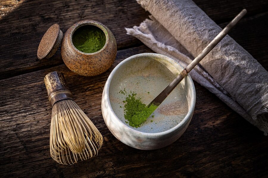 Matcha powder and bamboo chasen whisk, central to Kyoto tea ceremony