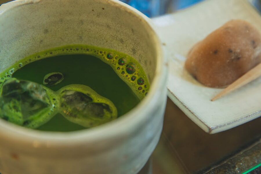 Bowl of matcha tea served with traditional wagashi sweets during tea ceremony