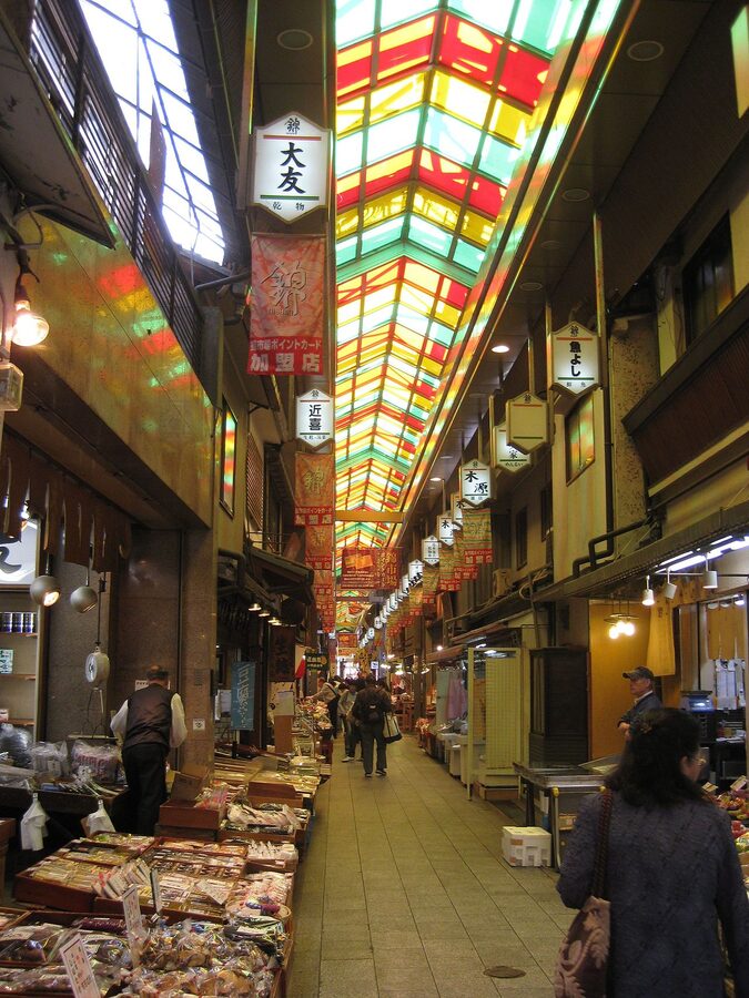 Shoppers walking through Nishiki Market's covered arcade in central Kyoto