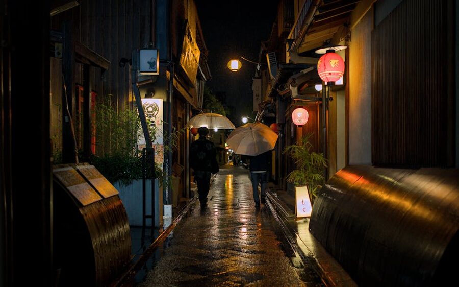 Pontocho alley on a rainy night in Kyoto, lanterns reflecting on wet stone