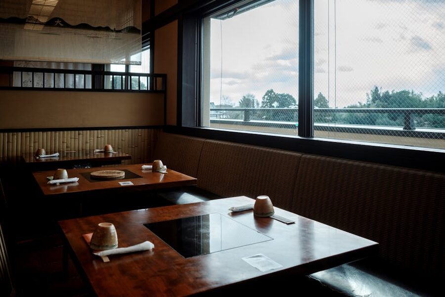 Wooden interior of a traditional Kyoto restaurant with counter seating and garden view