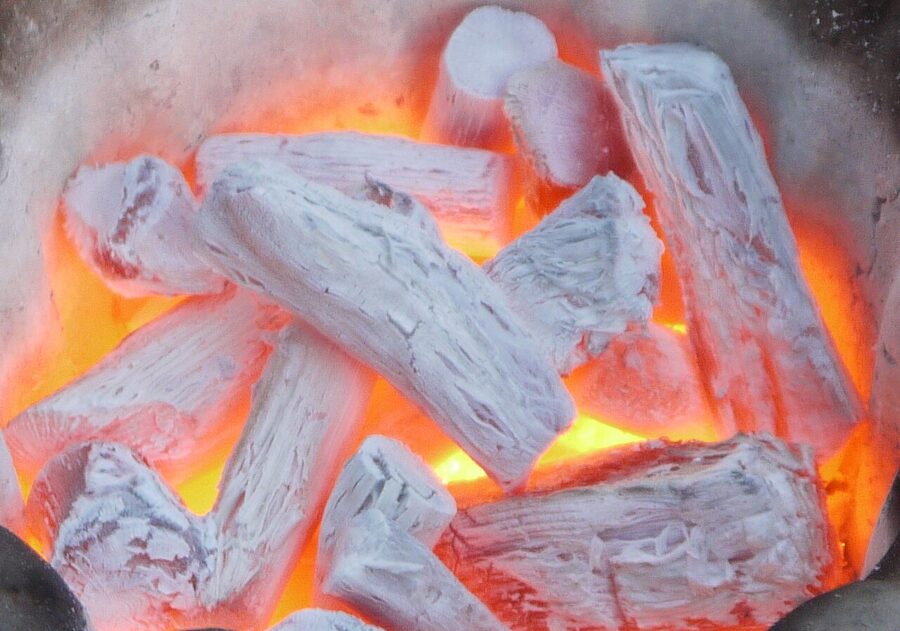 Binchotan charcoal glowing white-hot in a konro grill