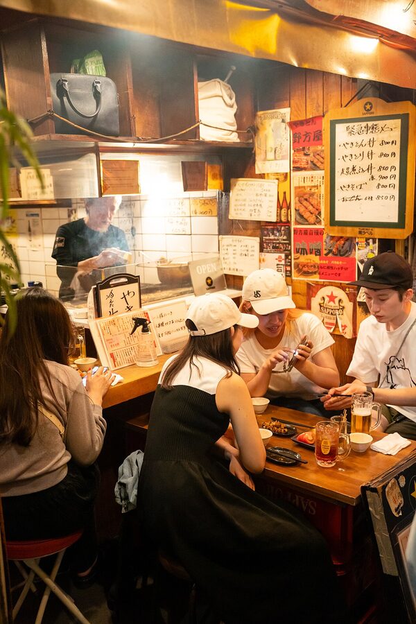 Yakitori smoke and lanterns inside Omoide Yokocho